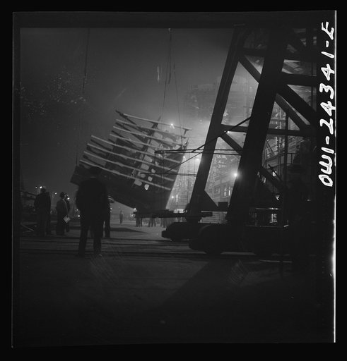 Bethlehem-Fairfield shipyards, Baltimore, Maryland. Lifting an after peak section at night