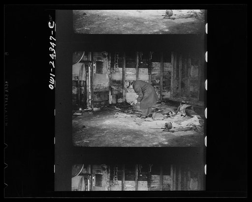 This filthy frame structure was once a "black market" for meats. Note the lime scattered on the floor, a black marketeer's gesture at cleanliness