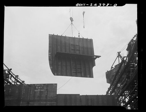 Bethlehem-Fairfield shipyards, Baltimore, Maryland. Lowering a transverse bulkhead into place