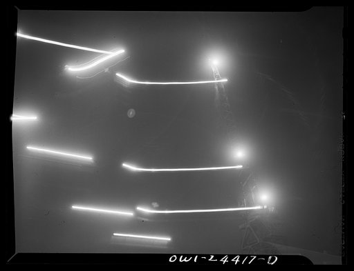 Bethlehem-Fairfield shipyards, Baltimore, Maryland. The outline of the cranes in the sky at night
