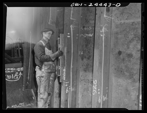 Bethlehem-Fairfield shipyards, Baltimore, Maryland. Testing the plumb of a bulkhead