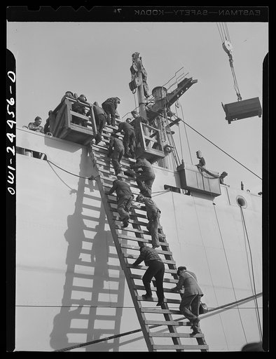 Bethlehem-Fairfield shipyards, Baltimore, Maryland. Workers leaving a vessel at the outfitting pier