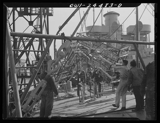 Bethlehem-Fairfield shipyards, Baltimore, Maryland. Lowering berthing to the deck of a vessel