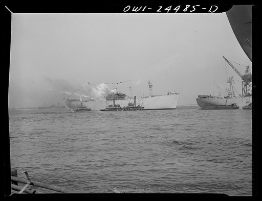 Bethlehem-Fairfield shipyards, Baltimore, Maryland. Tugs berthing a vessel after the launching