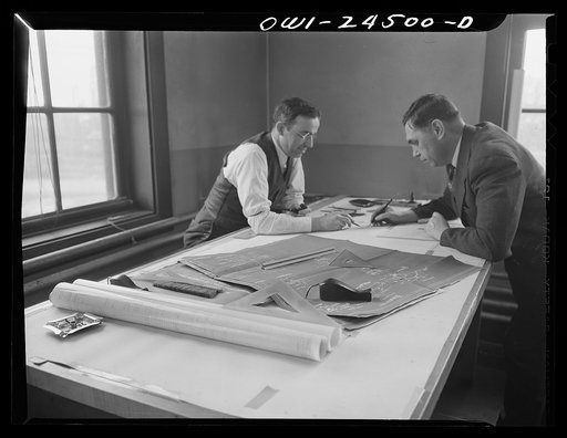 Bethlehem-Fairfield shipyards, Baltimore, Maryland. Discussing design changes in a drafting room