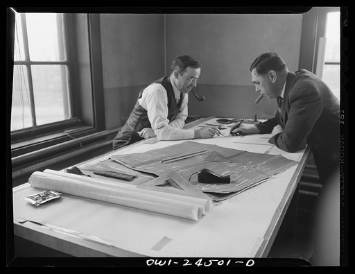 Bethlehem-Fairfield shipyards, Baltimore, Maryland. Discussing design changes in a drafting room