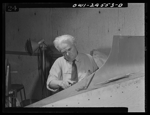 Untitled photo, possibly related to: El Segundo, California. Italian-American at work on a model of a military plane at the Douglas Aircraft plant