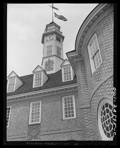 Williamsburg, Virginia. The capitol of the Virginia colony during the eighteenth century which was reconstructed and restored to its original state by John D. Rockefeller, Jr. during the 1930s. Capitol building with an early English flag and coat of arms