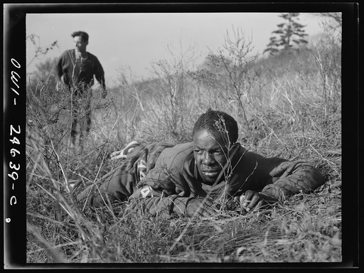 Untitled photo, possibly related to: High school Victory Corps. Learning the rudiments of advancing on an enemy will prove valuable to these boys if they are called to join their older brothers in the armed forces. This is part of the "commando" training given in physical education courses at Flushi
