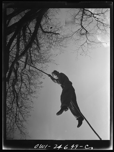 Untitled photo, possibly related to: Flushing High School, Queens, New York. A high school boy climbing a rope during a "commando" course