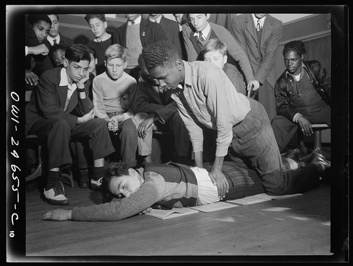Benjamin Franklin High School, New York, New York. Boys take one day a week from their English course for "war activities" in order to learn the basic principles of first aid