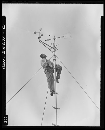 Untitled photo, possibly related to: Benjamin Franklin High School, New York, New York. Victory Corps boy learning to use the school's weather vane in weather forecasting, as part of his pre-aeronautics training in meteorology