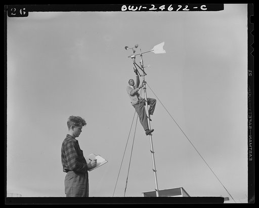 Untitled photo, possibly related to: Benjamin Franklin High School, New York, New York. Victory Corps boy learning to use the school's weather vane in weather forecasting, as part of his pre-aeronautics training in meteorology