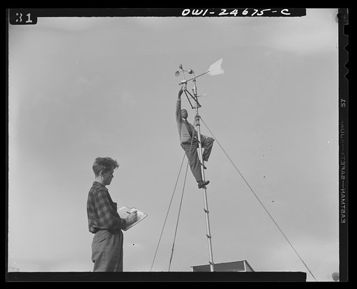 Untitled photo, possibly related to: Benjamin Franklin High School, New York, New York. Victory Corps boy learning to use the school's weather vane in weather forecasting, as part of his pre-aeronautics training in meteorology