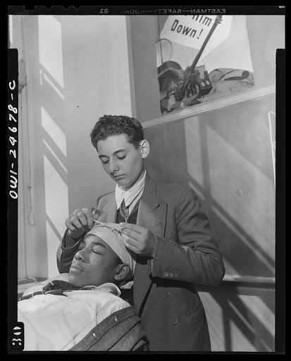 Benjamin Franklin High School, New York, New York. Boys take one day a week from their English course for "war activities" in order to learn the basic principles of first aid