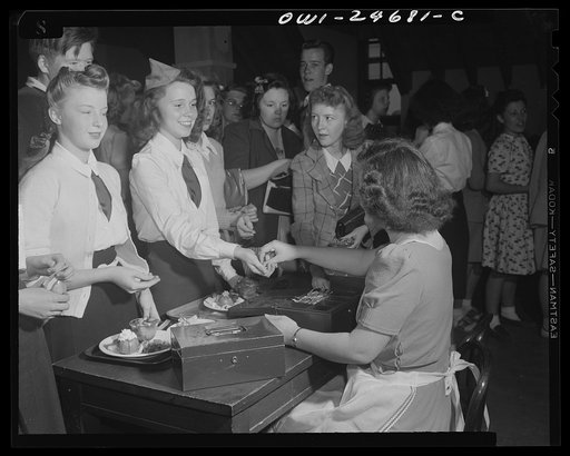 Benjamin Franklin High School, New York, New York. Home economics students contributing to the school's Victory Corps program by preparing and serving food in the student-operated cafeteria