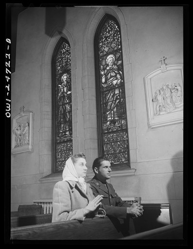 Untitled photo, possibly related to: Buffalo, New York. Frank and Laura Czaya praying in church one week after Easter. They were married six months before Frank was drafted. He is now a corporal, stationed in Arkansas and is home on a ten day furlough. Laura works in the Symington-Gould plant; lives