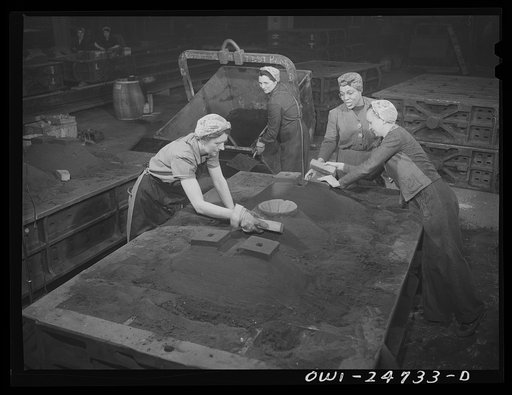 Buffalo, New York. Symington-Gould, makers of tank, ship, and railroad parts. Mold department. After molds have been pounded with air hammer, women put heads on the molds, that is put extra protective sand on top, and insert the cut core (round funnel to left of woman in foregound) through which mol