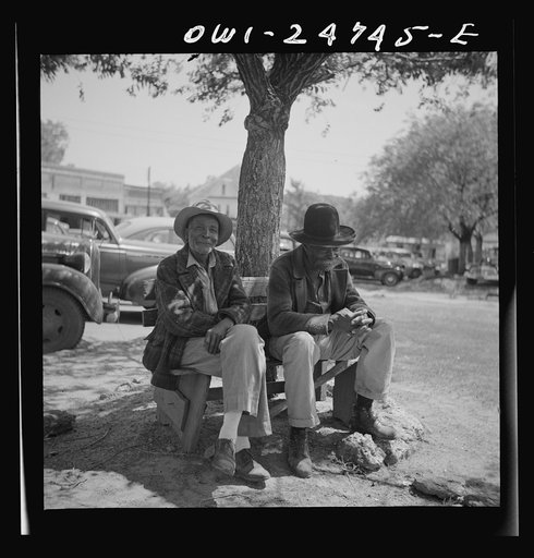 Untitled photo, possibly related to: San Augustine, Texas. Men talking on a park bench in Courthouse Square