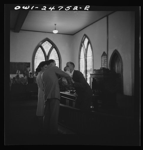 San Augustine, Texas. Reverend Dubberly returning an infant to its parents after the baptismal ceremony
