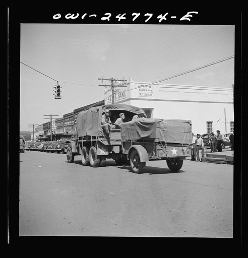 Untitled photo, possibly related to: San Augustine, Texas. Troop movement through the main street