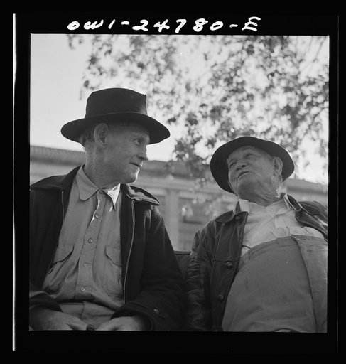 Untitled photo, possibly related to: San Augustine, Texas. Men talking on a park bench in Courthouse Square