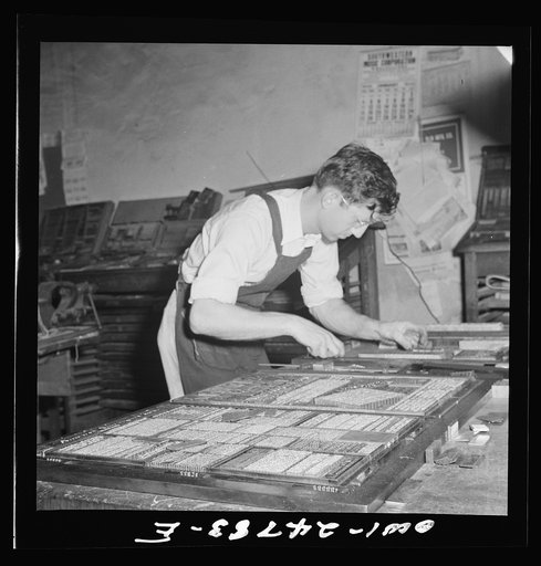Untitled photo, possibly related to: San Augustine, Texas. Harlan [i.e. Arlan] Hayes working at night, setting up page for the weekly edition of the San Augustine Tribune