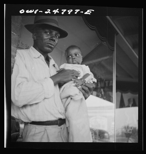 San Augustine, Texas. Father and daughter in front of the drugstore