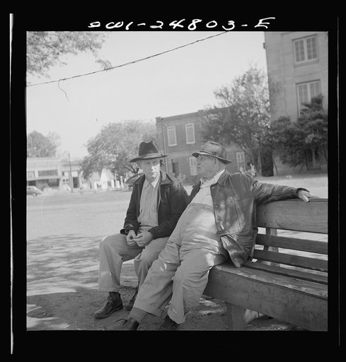 Untitled photo, possibly related to: San Augustine, Texas. Men talking on a park bench in Courthouse Square