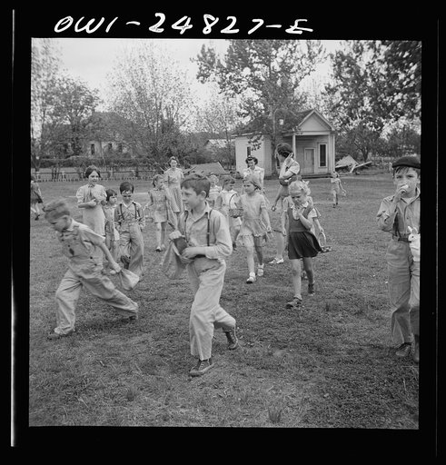 San Augustine, Texas. Children having an Easter egg hunt on the school grounds on the last day of school before Easter vacation