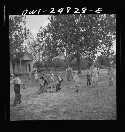 San Augustine, Texas. Children having an Easter egg hunt on the school grounds on the last day of school before Easter vacation