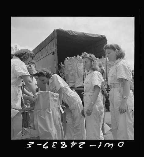 Untitled photo, possibly related to: San Augustine, Texas. Girls loading chairs which they made in NYA (National Youth Administration) woodworking shop onto a truck