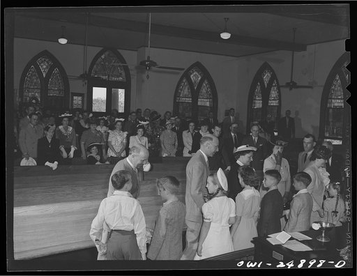 Untitled photo, possibly related to: San Augustine, Texas. Reverend Dubberly asking questions of children being received into the church. Their parents stand behind them