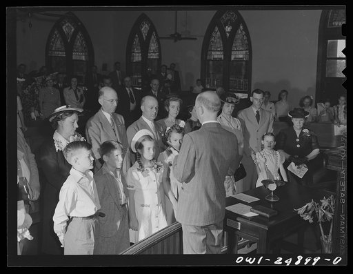 San Augustine, Texas. Reverend Dubberly asking questions of children being received into the church. Their parents stand behind them