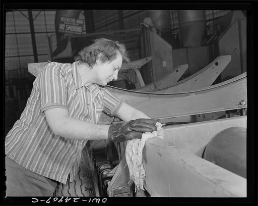 Milwaukee, Wisconsin. War production workers at the Heil Company making gasoline trailer tanks for the U.S. Army Air Corps. Irean Smotinski, age twenty-nine, and ex-housewife, cleaning a chassis before it goes to the paint room