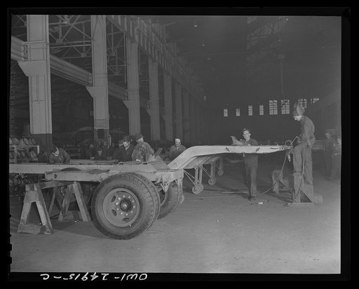 Untitled photo, possibly related to: Milwaukee, Wisconsin. War production workers at the Heil Company making gasoline trailer tanks for the U.S. Army Air Corps. Assembling a chassis