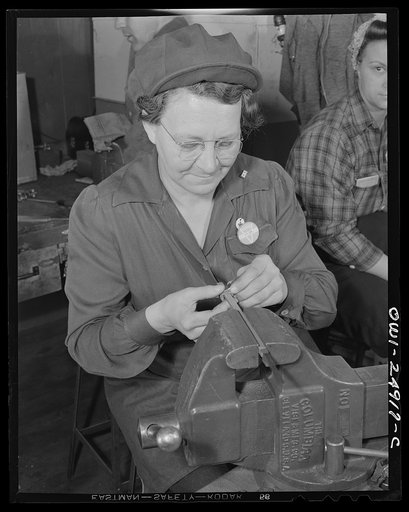 Milwaukee, Wisconsin. War production workers making M5 and M7 guns for the U.S. Army. Ex-housewife, age forty-nine, filing small parts. Her son and son-in-law are in the armed service