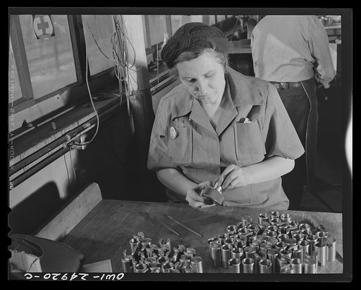 Milwaukee, Wisconsin. War production workers making M5 and M7 guns for the U.S. Army. Ex-housewife, age forty-six, checking small parts for a gun with steel gage. Her son is in the armed service