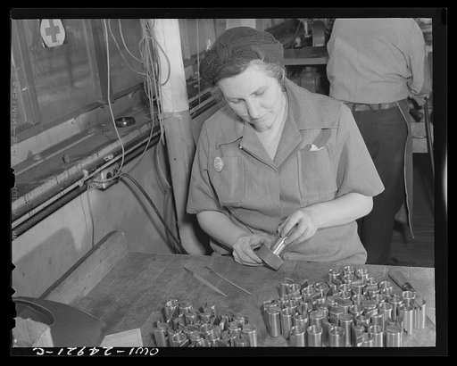 Untitled photo, possibly related to: Milwaukee, Wisconsin. War production workers making M5 and M7 guns for the U.S. Army. Ex-housewife, age forty-six, checking small parts for a gun with steel gage. Her son is in the armed service
