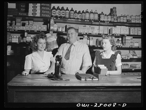 San Augustine, Texas. Clyde Smith, grocer, with his two daughters