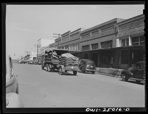 Untitled photo, possibly related to: San Augustine, Texas. Troop movement going through the main street on a Saturday morning