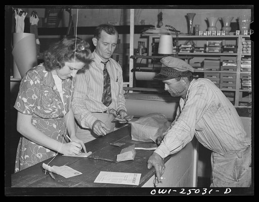 San Augustine, Texas. R.V. Hall, grocer, settling an account with one of his customers