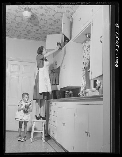 San Augustine, Texas. Mrs. Ramsey, a lawyer's wife, putting home canned goods on the pantry shelf
