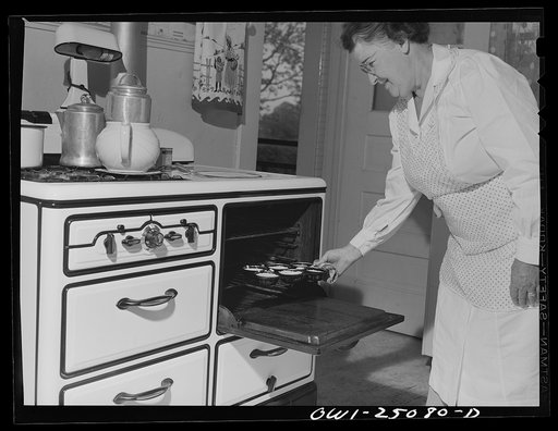 San Augustine, Texas. Mrs. Rushing, wife of the mayor, putting cornbread biscuits in the oven