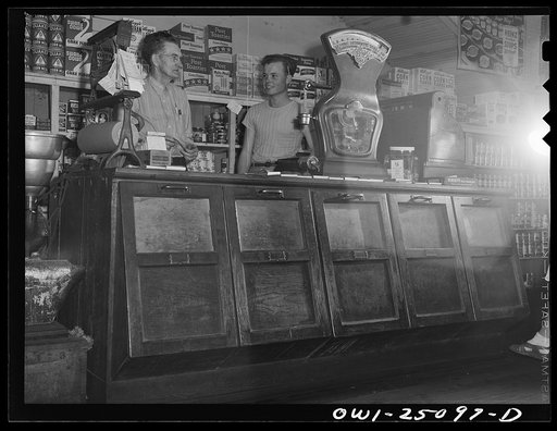 Untitled photo, possibly related to: San Augustine, Texas. I.V. Childers, grocer, with his clerk who has just turned eighteen and is going to be inducted into the Army