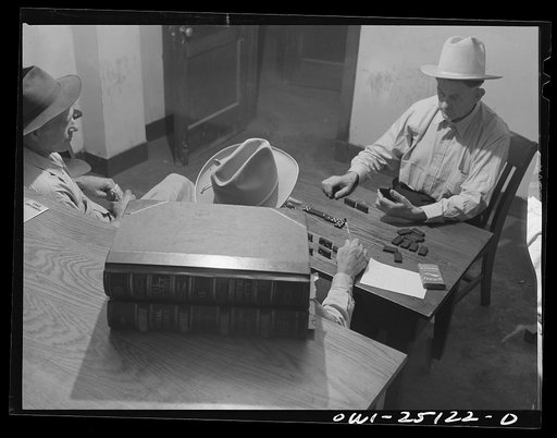 San Augustine, Texas. H.L. Armstrong, Justice of the Peace, in a dominoe game with Jeff Davis, night marshall