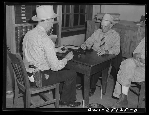 Untitled photo, possibly related to: San Augustine, Texas. Lud Behnholder, filling station operator, watching night marshall Jeff Davis and the Justice of the Peace H.L. Armstrong in a domino game