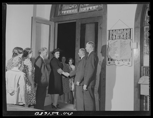 San Augustine, Texas. Reverend Dubberly, Methodist minister, shaking hands with his congregation as they leave church after Good Friday evening service