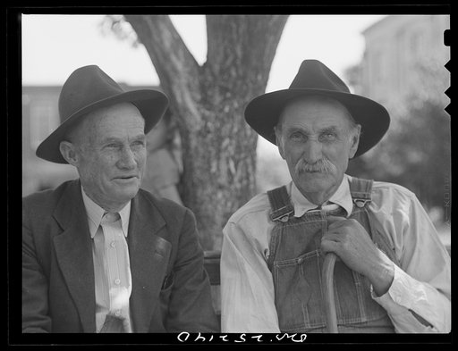 San Augustine, Texas. Old men sitting on a bench in courthouse square on Saturday afternoon