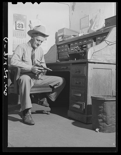 San Augustine, Texas. Sheriff Halberd [i.e., Halbert] cleaning his gun in his office